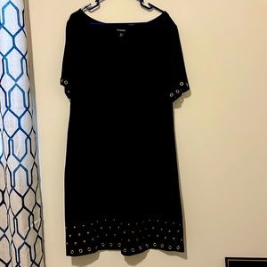 Cute black and a-line dress with gold ring accents.